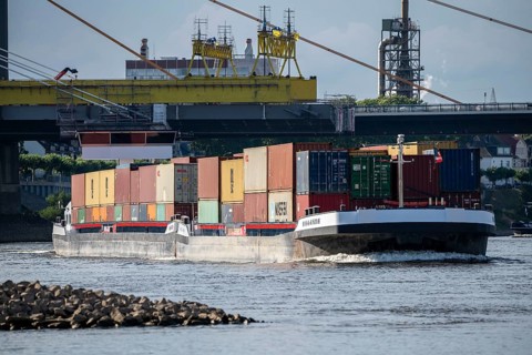 Inland navigation on the Rhine near Duisburg, container ship Hollande, fully loaded, Rhine bridge