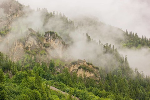 Wisps of mist cover the Karwendel mountains in the Großer Ahornboden nature reserve, Eng Valley,