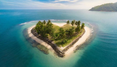 Symbol, small heart-shaped island in the sea, love island, honeymoon, palm beach, aerial view,