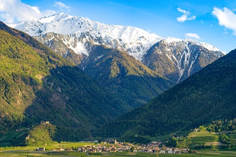 View of the village of Morter with the mountains of the Stelvio National Park behind it, evening