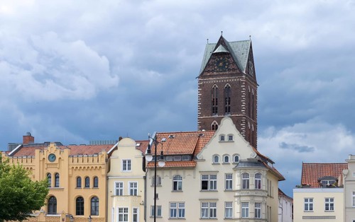 Historic houses on the market square, behind the remaining tower of St Mary's Church, Wismar,