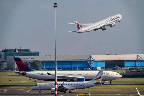 Amsterdam Schiphol Airport, aircraft on the taxiway, Qatar Airways plane takes off from the