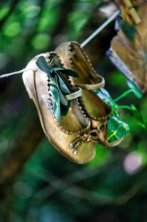 Children's shoes, shoes hanging on a washing line in the woods, vintage, decoration, Lost Gardens