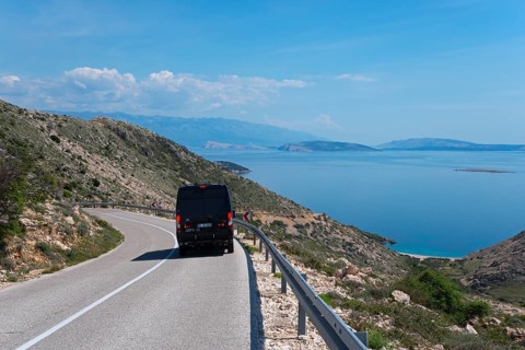 Scenic road with a motorhome and breathtaking sea view, camper, mountain road towards Stara Baška,