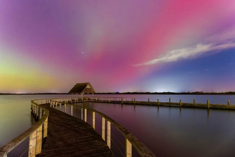 Wooden jetty and Northern Lights, Aurora borealis, polar lights over Lake Hemmelsdorf,