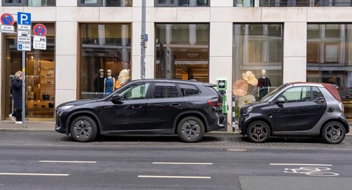 Charging station for electric vehicles, BMW SUV and Smart small car charging on the street,