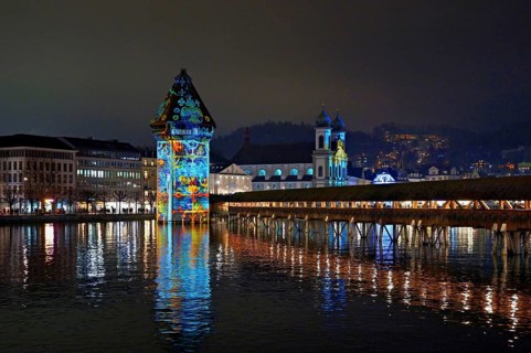 Wassertum with light installation, Chapel Bridge on the right, Jesuit Church on the Reuss at dusk