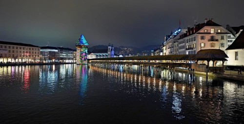 Wassertum with light installation, Chapel Bridge on the right, Jesuit Church on the Reuss at dusk