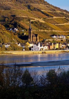 View across the Rhine in the late evening light from Bacharach to Lorch with the parish church of