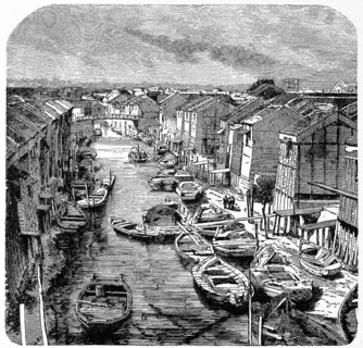 Wooden houses and sandy paths along a canal in old Tokyo, many rowing boats for transporting people
