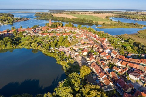 Aerial view of Röbel, lake Mönchteich in front, St. Mary's Church in center of town, lake Müritz,