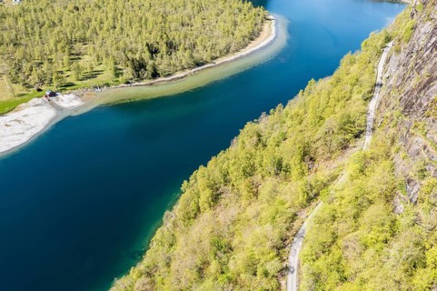 Aerial view of lake Lovatnet (or: Loenvatnet), gravel mountain road above the lake, valley Lodalen