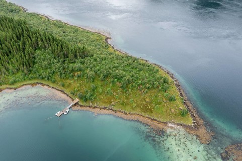 Aerial view of a bay at the Raftsund, single hut with boat, fjord between Lofoten and Vesteralen,