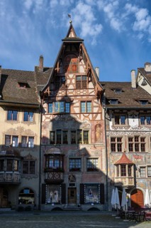 Imposing, historic half-timbered buildings with detailed facade paintings on the market square in