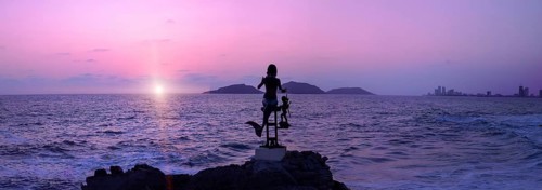Mexico, statues near Mazatlan sea promenade, El Malecon near tourist beaches and scenic sunset