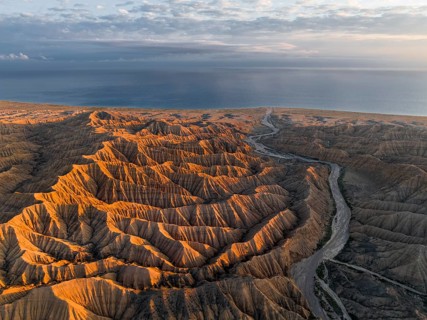 Landscape of eroded hills at Lake Issyk Kul, Badlands at sunrise, aerial view, Canyon of the