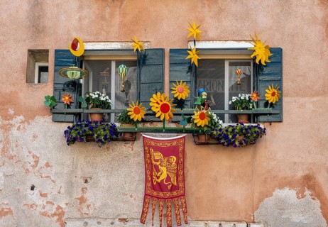 Windows decorated with flowers on a house facade, Venetian flag, Venice, Veneto, Italy, Europe