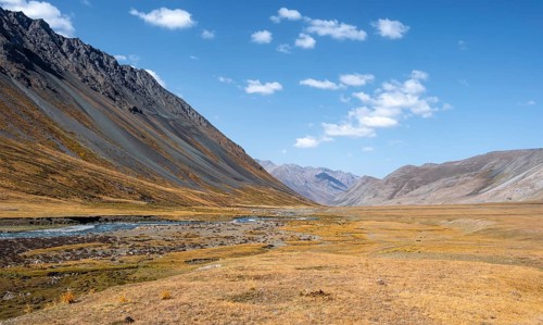 Burkhan valley with river, mountain landscape with golden meadows, Terskey Ala-Too, Tien Shan,