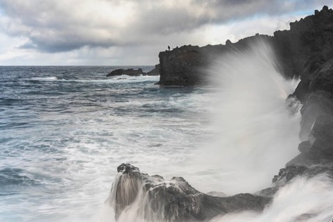 Angler on the beach and rocks, surf on Lanzarote, Spain, Europe