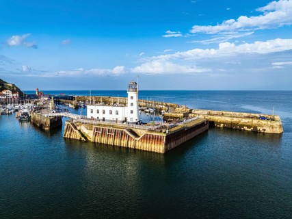 Scarborough Lighthouse and Harbour from a drone, Vincent Pier, Scarborough, North Yorkshire,