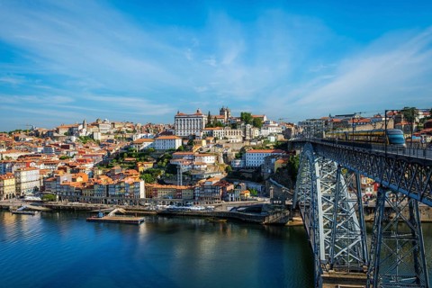 View of Porto city and Douro river and Dom Luis bridge I with metro tram from famous tourist