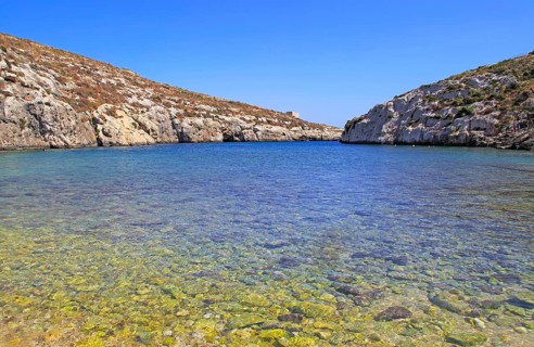 Shoreline clear blue sea water, Mgarr ix-Xini coastal inlet, island of Gozo, Malta, Europe