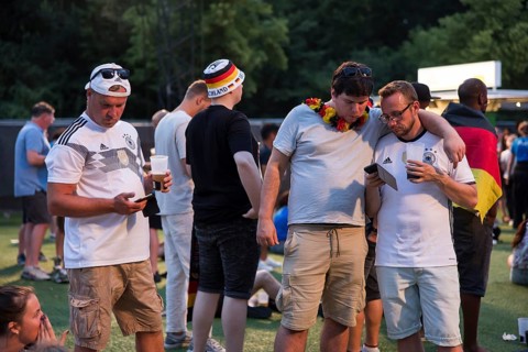 Fassball fans celebrate and gather information in the fan zone at the Brandenburg Tor after the