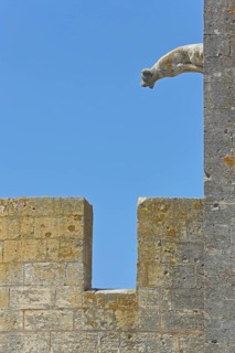 Gargoyle with battlements at the Porte de la Reine, city gate, city wall, detail, dog figure,
