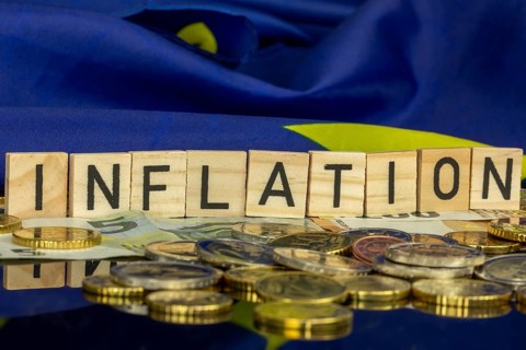 Symbolic image of inflation (in the euro area) : The word INFLATION in letter cubes on euro coins