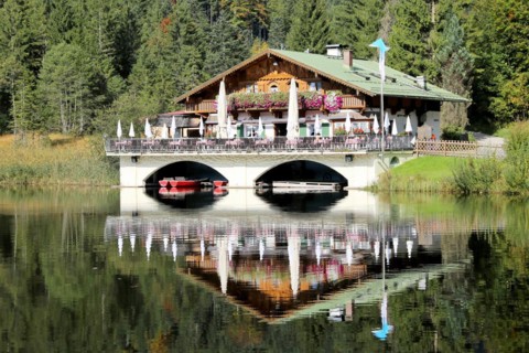 The picturesque Pflegersee lake near Garmisch, with the mountain inn in the background