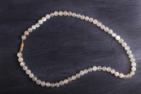 Agate colored beads on a black background. top view, close up