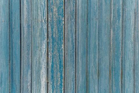 Garage door boards stained blue with worn paint. Brittany France