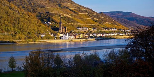 View across the Rhine in the late evening light from Bacharach to Lorch with the parish church of