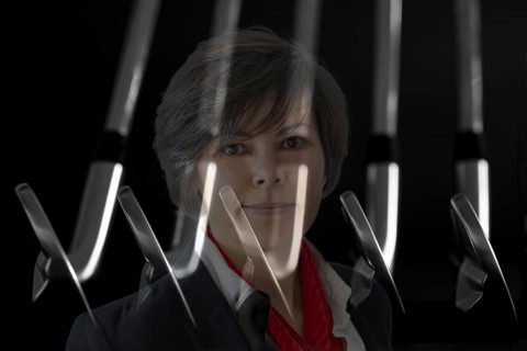 Business Woman and Golf Clubs Blades on Black Background in Switzerland