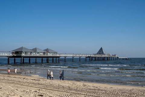 Holidaymakers walking on the beach, pier, Heringsdorf, Usedom Island, Baltic Sea,