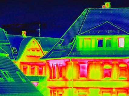 Apartment block, facade of a residential building with windows. Thermal image or thermography,