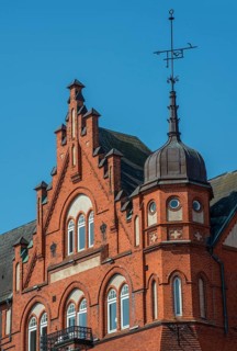 House with tower, gable and spire in brick architecture built in 1898 in Ystad, Skåne County,
