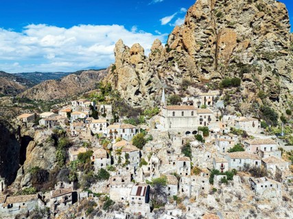 Mountains and Olive groves around Ghost Town from a drone, Pentedattilo Village, Calabria, Italy,