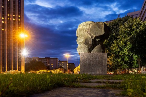 Karl Marx Monument at night. A 40-tonne sculpture, the city's most famous landmark. Congress Hotel.
