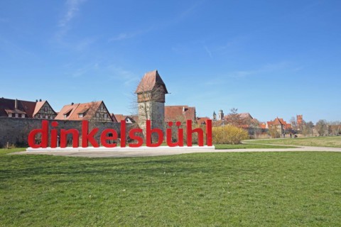View of historic town wall with town fortifications and Bäuerlinsturm and inscription Dinkelsbühl,