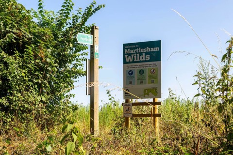 Sign for Martlesham Wilds, Suffolk Wildlife Trust farmland rewilding project, near Woodbridge,