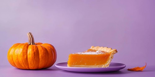 Banner with slice of pumpkin pie with orange pumpkin on purple violet background with copy space.