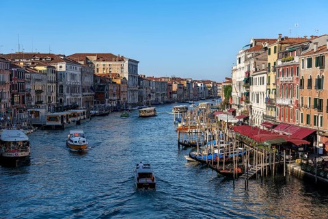 View of the Grand Canal with water taxis and vaporetto in the evening light, view from the Rialto