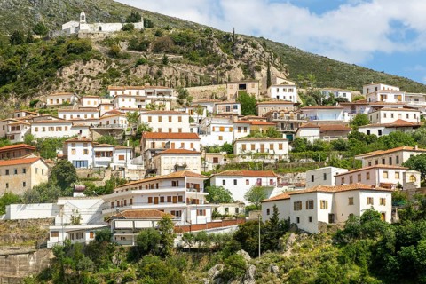 View of village of Dhermi, Albania whitewashed buildings on mountainside