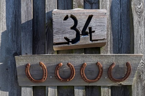 Horseshoe under a house number on a barn, Bavaria, Germany, Europe