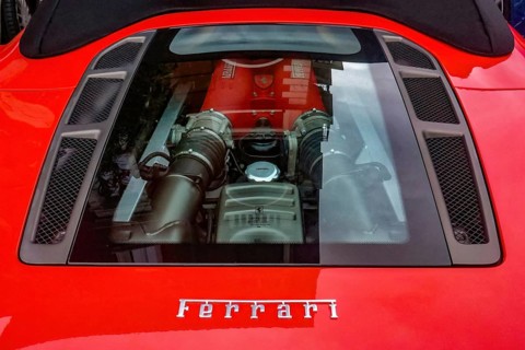 View of transparent bonnet and engine of sports car Ferrari F 430 F430 Spider in colour Corsa Rosso