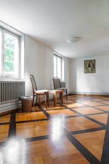 Bright room corner with artwork on the wall, chairs and wooden floor, Kirchheim Teck, Germany,