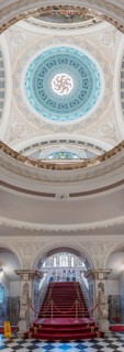 Magnificent interior with red and gold staircase and imposing domed ceiling, Belfast