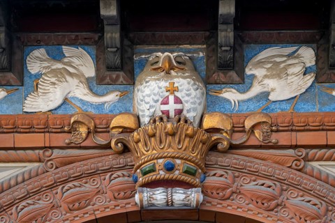 Detail, historic façade with decorative bird reliefs and owl on Danish crown, Carlsberg Museum,