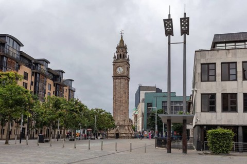 Historic clock tower in a public square surrounded by modern urban architecture, Belfast